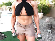 Brandi Mae the hot bodybuilder pumps up her hard body naked outside.