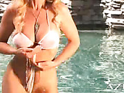 Sexy busty blonde, Dyanna Lauren, dances in the cool clear water of the pool wearing an itty bitty swimsuit.  She gets so turned on she just has to play with her pretty pussy!